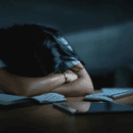 LasCruces burnout A woman sleeping on top of paperwork.